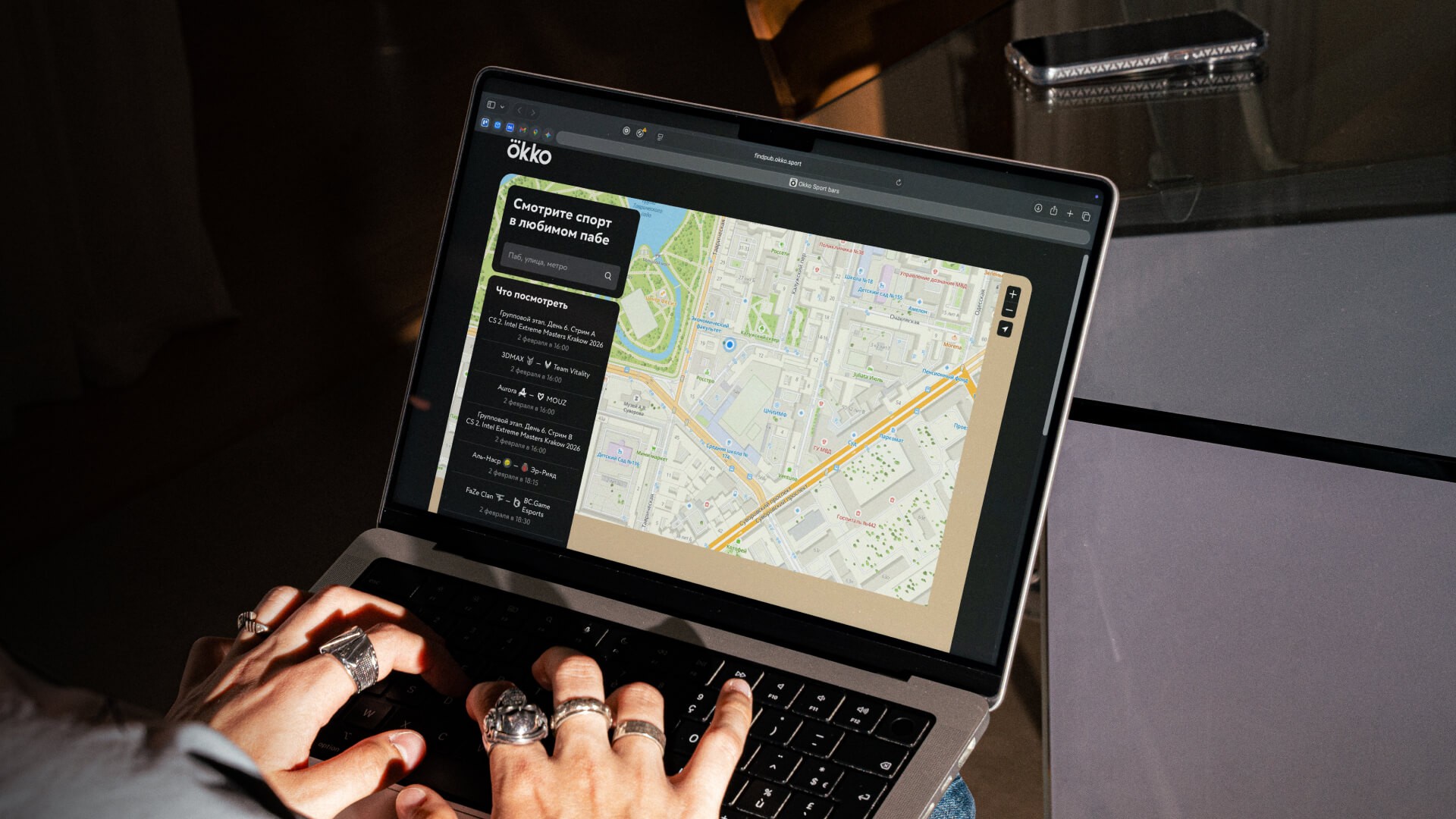 An interactive bar map interface on a laptop screen: a web service with venue selection, routes, and location filters in a lifestyle setting.